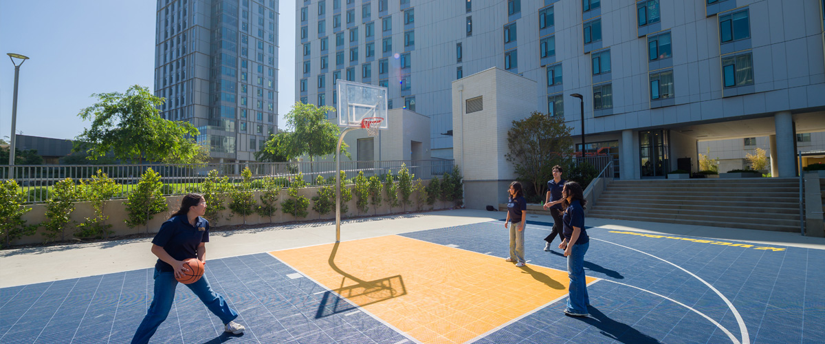 attendees playing basketball outside
